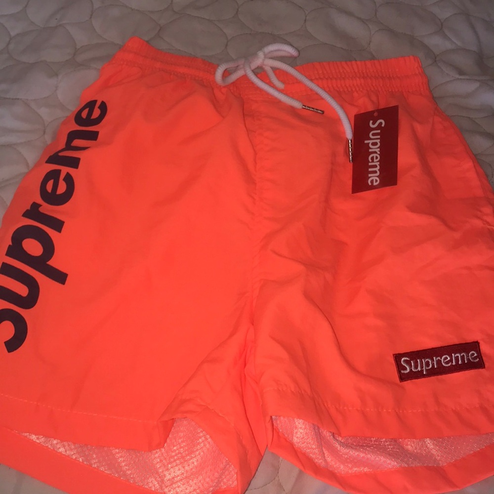 bright orange supreme shorts (waterproof) tags on